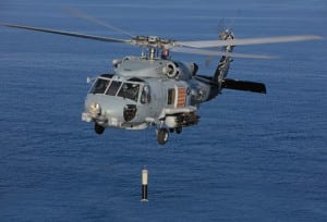 A U.S. Navy MH-60R Helicopter using an AN/AQS-22 Airborne Low Frequency Sonar (ALFS) system as an integrated dipping sonar system. (Photo: Lockheed Martin)