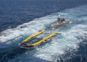 The Mine Countermeasures Unmanned Surface Vehicle (MCM USV) in Minehunt configuration performs launch and recovery operations during Initial Operational Test and Evaluation (IOT&E) in August 2022. (Photo: U.S. Navy)