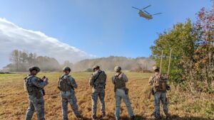 Airmen at Joint Base Langley Eustis, Virginia perform field exercises during Force Protection Operational Rehearsal in November 2022. An Airman (far right) carries the dismounted “manpack” JCREW system to show capabilities. (Photo: U.S. Navy)