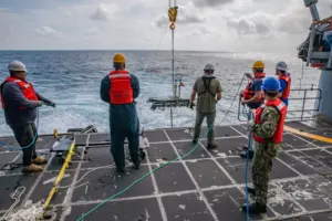 Sailors and civilian mariners launch a Wave Glider Unmanned Surface Vehicle from the fantail of expeditionary fast transport ship USNS Burlington (T-EPF 10) in the Caribbean Sea as a part of the UNITAS U.S. Naval Forces Southern Command/U.S. 4th Fleet Unmanned Integration Campaign. (Photo: U.S. Navy by Mass Communication Specialist 2nd Class Conner Foy)