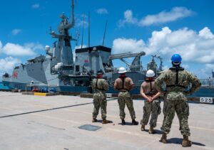 Sailors assigned to U.S. Navy Support Facility Diego Garcia watch as HMS Tamar (P233), the fourth of the five Batch 2 River-class offshore patrol vessels operated by the UK Royal Navy, arrives in Diego Garcia for a scheduled port visit Feb. 15, 2023. (Photo: U.S. Navy by Mass Communication Specialist 2nd Class Jesus O. Aguiar)