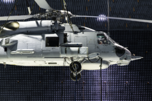 A Lockheed Martin Advanced Off-Board Electronic Warfare (AOEW) system pod attached to the side of an MH-60R helicopter inside the anechoic chamber at the Naval Air Warfare Center Aircraft Division at Naval Air Station Patuxent River. (Photo: U.S. Navy by Terri Thomas)