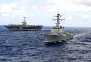 The Arleigh Burke-class guided-missile destroyer USS Pickney, right, and the Nimitz-class aircraft carrier USS John C. Stennis are underway in the Pacific Ocean in 2011. (Photo: U.S. Navy by Petty Officer 3rd Class Walter Wayman)