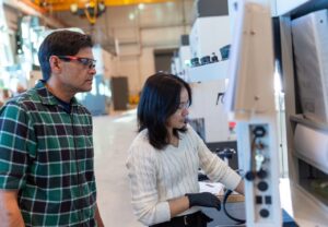 Jim Hook, an Accelerated Training for Defense Manufacturing (ATDM) instructor, teaches a student how to use a Haas CNC machine at the newly opened National Training Center in Danville, Virginia. This state-of-the-art facility, which opened on January 13, 2025, expands the program's capacity to train skilled workers for submarine and surface ship manufacturing. (Photo: U.S. Navy, ATDM)